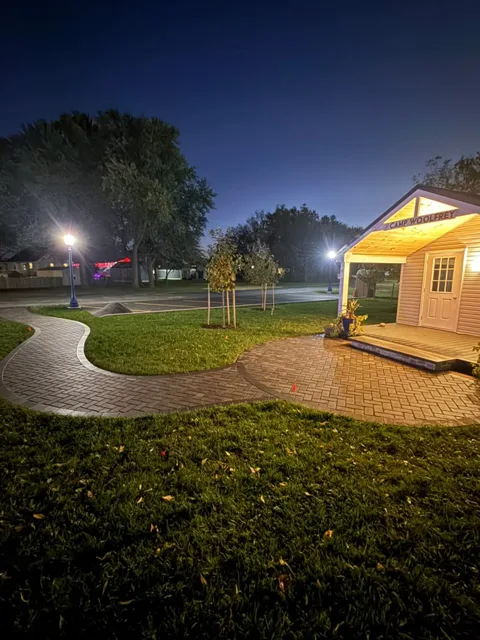 Curved paver walkway leading to the park pavilion at dusk
